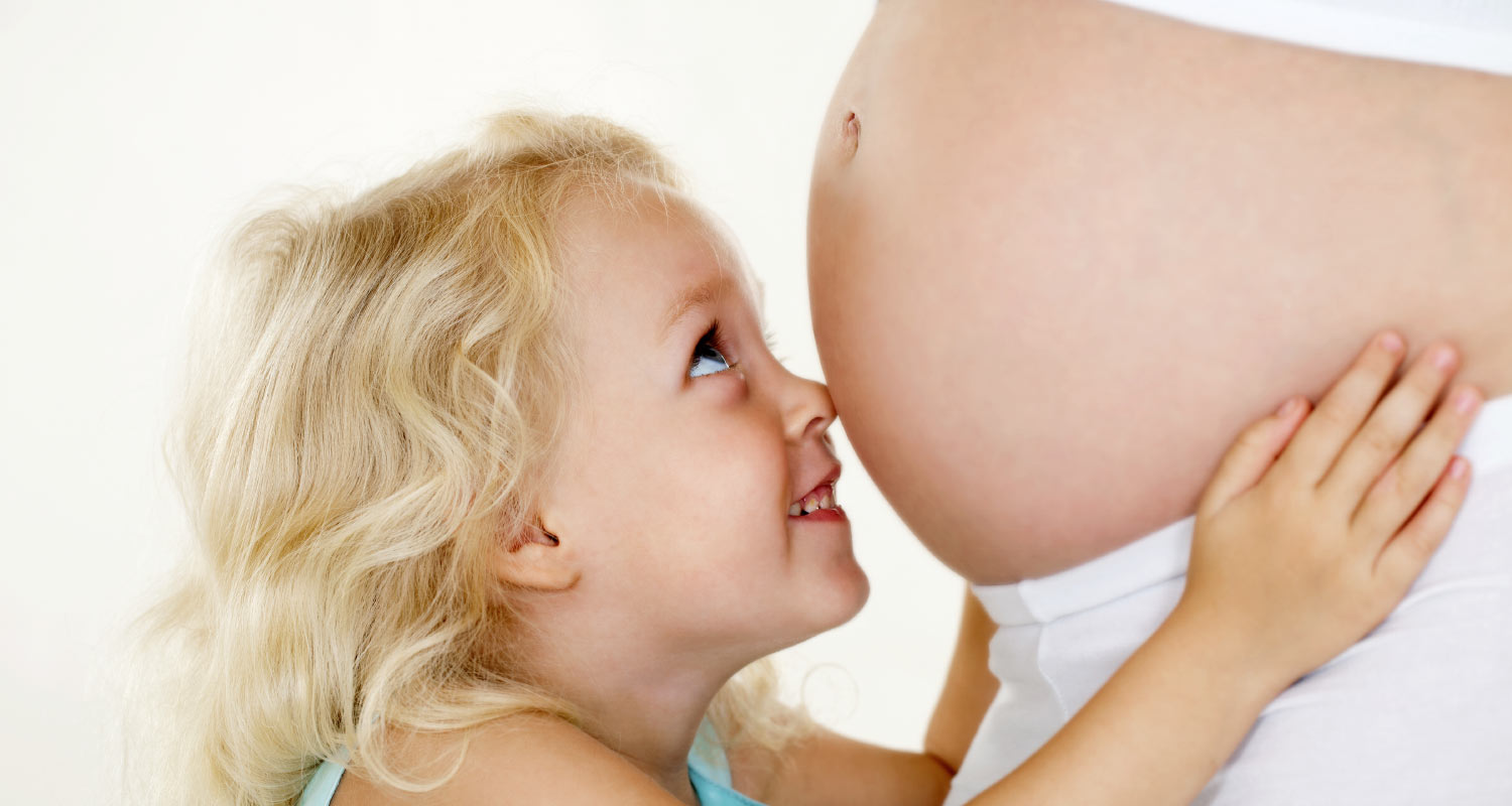 Child Holding her Mommy's Tummy